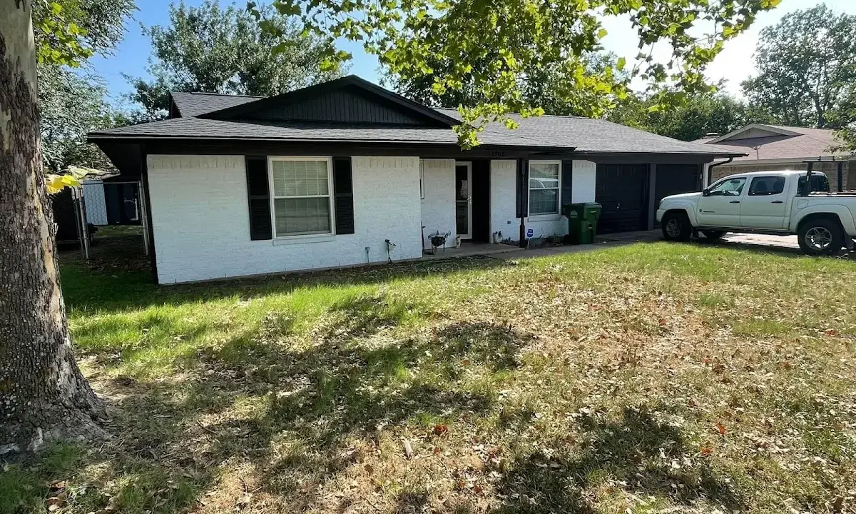 Professional roofing crew working on a residential roof in Muscle Shoals